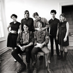 The Arcade Fire pose in chairs